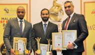 UDC officials pose with four Golden Globe Tigers Awards.