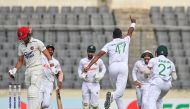 Bangladesh's Shoriful Islam (2R) celebrates with teammates after taking the wicket of Afghanistan's Ibrahim Zadran (L) during the third day of the Test cricket match between Bangladesh and Afghanistan at the Sher-e-Bangla National Cricket Stadium in Dhaka on June 16, 2023. (Photo by Munir uz ZAMAN / AFP)
 