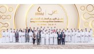 Minister of State for Energy Affairs and the President and CEO of QatarEnergy H E Saad Sherida Al Kaabi with officials and long-serving employees during the ceremony.
