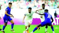 Qatar's Ali Asad (left) in action during the match against Haiti, yesterday.