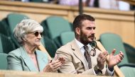 Former British football player David Beckham and his mother Sandra Beckham applaud as they sit in the royal box in Center Court during the women's singles tennis match between Russia's Daria Kasatkina and Britain's Jodie Burrage on the third day of the 2023 Wimbledon Championships at The All England Tennis Club in Wimbledon, southwest London, on July 5, 2023. (Photo by SEBASTIEN BOZON / AFP)
