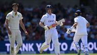 England's Harry Brook (C) and England's Joe Root (R) take a run on day four of the third Ashes cricket Test match between England and Australia at Headingley cricket ground in Leeds, northern England on July 9, 2023. (Photo by Paul ELLIS / AFP) 