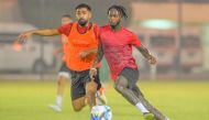 Al Markhiya players in action during a training session.