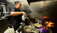 Chef Tue Nguyen cooks her Didi Fried Rice in the kitchen of her soon-to-open first restaurant, called Di Di (Let's Go! in Vietnamese), in West Hollywood, California. (Photo by Frederic J. Brown / AFP)