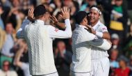 England's Stuart Broad (R) celebrates with England's James Anderson (C) and England's Zak Crawley (L) after England's victory on day five of the fifth Ashes cricket Test match between England and Australia at The Oval cricket ground in London on July 31, 2023. (Photo by Adrian DENNIS / AFP) 