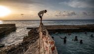 Cubans swim in a natural swimming pool off the coast of Havana on August 4, 2023. Photo by Yamil LAGE / AFP