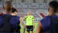 Al Duhail coach Hernan Crespo speaks to players during a training session.