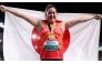 Gold medalist, Japan's Haruka Kitaguchi celebrates with her National flag and gold medal after winning the women's javelin throw final during the World Athletics Championships at the National Athletics Centre in Budapest on August 25, 2023. (Photo by Kirill Kudryavtsev / AFP)