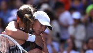 Poland's Iga Swiatek embraces her best friend defeated Slovenia's Kaja Juvan during the US Open tennis tournament women's singles third round match at the USTA Billie Jean King National Tennis Center in New York City, on September 1, 2023. (Photo by Kena Betancur / AFP)