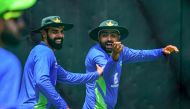 Pakistan's captain Babar Azam (R) and Shadab Khan gesture during a practice session at the R. Premadasa Stadium in Colombo on September 9, 2023. (Photo by Ishara S. KODIKARA / AFP)