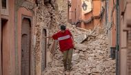 A resident navigates through the rubble following a 6.8-magnitude quake in Marrakesh on September 9, 2023. (Photo by FADEL SENNA / AFP)
