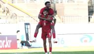 Qatar players celebrate during the match.