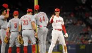 File photo: Designated hitter Shohei Ohtani #17 of the Los Angeles Angels is greeted by Cincinnati Reds infielders during a pitching change after Ohtani's double during the fifth of game two of a doubleheader at Angel Stadium of Anaheim on August 23, 2023 in Anaheim, California. Kevork Djansezian/Getty Images/AFP

