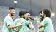 Al Sadd players celebrate after Ali Asad’s (centre) goal against Al Gharafa yesterday.    
