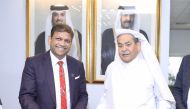 Officials exchange documents during the collaboration to pioneer new digital frontiers in Qatar.