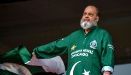 Chacha Mohammad Basheer, a Pakistani fan, waves national flag during the 2023 ICC Men's Cricket World Cup one-day international (ODI) match between Pakistan and Netherlands at the Rajiv Gandhi International Stadium in Hyderabad, India, on October 6, 2023. (Photo by Noah Seelam / AFP)