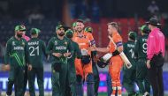 Netherlands' Logan van Beek (4R) and Paul van Meekeren (C) shake hands with Pakistan's players at the end of the 2023 ICC Men's Cricket World Cup one-day international (ODI) match between Pakistan and Netherlands on October 6, 2023. (Photo by Noah Seelam / AFP)