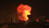 A fireball erupts during Israeli bombardment of Gaza City on October 9, 2023. (Photo by MAHMUD HAMS / AFP)

