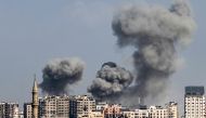 Smoke plumes billow during Israeli air strikes in Gaza City on October 12, 2023. (Photo by Mohammed Abed / AFP)
