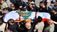Mourners carry the casket of Lebanese Reuters video journalist Issam Abdallah, killed on October 13 by Israeli shelling at Alma al-Shaab border village with Israel while covering cross border shelling, during his funeral in the village of El-Khiam on October 14, 2023. (Photo by Fadel ITANI / AFP)
