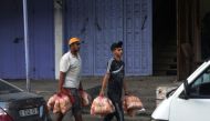 Men carry bags of bread in the Rafah refugee camp, in the southern of Gaza Strip on Octobers 15, 2023, as fighting between Israel and the Hamas movement continues, with Israel cutting off water, fuel and food supplies into the enclave. Photo by MOHAMMED ABED / AFP