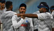 Sri Lanka's Kusal Mendis (centre) listens to his team consultant Mahela Jayawardene (right) during a practice session on the eve of their 2023 ICC Men's Cricket World Cup one-day international (ODI) match against Australia at the Ekana Cricket Stadium in Lucknow on October 15, 2023. (Photo by Arun Sankar / AFP)
