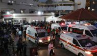 Ambulances carrying victims of Israeli strikes crowd the entrance to the emergency ward of the Al-Shifa hospital in Gaza City on October 15, 2023. (Photo by Dawood NEMER / AFP)