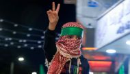 A Palestinian boy flashes the victory sign during a protest in Nablus city in the occupied West Bank on October 17, 2023. (Photo by Zain JAAFAR / AFP)