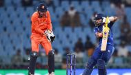 Sri Lanka's Sadeera Samarawickrama (R) plays a shot as Netherlands' captain Scott Edwards watches during the 2023 ICC Men's Cricket World Cup one-day international (ODI) match between Netherlands and Sri Lanka at the Ekana Cricket Stadium in Lucknow on October 21, 2023. (Photo by Noah SEELAM / AFP)
