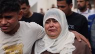 A woman is comforted as she grieves at a hospital where the injured and dead are brought following an Israeli air strike on Rafah, the southern Gaza Strip on October 23, 2023. (Photo by Mohammed Abed / AFP)