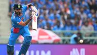 India's Virat Kohli watches the ball after playing a shot during the 2023 ICC Men's Cricket World Cup one-day international (ODI) match between India and England at the Ekana Cricket Stadium in Lucknow on October 29, 2023. (Photo by Sajjad HUSSAIN / AFP) 
