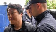 South Korean cryptocurrency entrepreneur, co-founder of Terraform Labs (Terra Luna), Do Kwon (L), is taken to court in Podgorica on May 11, 2023, following his arrest on March 24 at the Montenegrin capital's international airport. (Photo by SAVO PRELEVIC / AFP)

