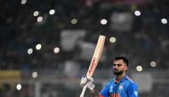 India's Virat Kohli celebrates after scoring a century (100 runs) during the 2023 ICC Men's Cricket World Cup one-day international (ODI) match between India and South Africa at the Eden Gardens in Kolkata on November 5, 2023. (Photo by DIBYANGSHU SARKAR / AFP)