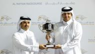 Qatar Racing and Equestrian Club’s Acting CEO Bader Mohammed Al Darwish presents the Barzan Cup winner's trophy to representative of Al Wasmiyah Farm after Gubbass was ridden to victory by Jefferson Smith during the Eighth Al Rayyan Meeting, yesterday. PICTURES: JUHAIM/QREC