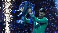 Serbia's Novak Djokovic poses with the trophy after winning the final match against Italy's Jannik Sinner at the ATP Finals tennis tournament in Turin on November 19, 2023. (Photo by Tiziana Fabi / AFP)