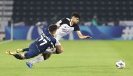 Al Sadd's Iranian defender Amin Hazbavi (right) and Nasaf's Oybek Bozorov vie for the ball possession during yesterday's match at Jassim Bin Hamad Stadium. PICTURES: Mohammed Farag 
