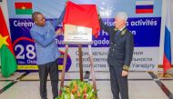 Russia's ambassador to Ivory Coast, Alexey Saltykov (right) and Burkina Faso's Minister of Foreign Affairs, Karamoko Jean-Marie Traore, unveil a plaque during a ceremony to mark the re-opening of the Russian Embassy in Burkina Faso, in Ouagadougou, on December 28, 2023. (Photo by Kiemtore Lassane Bruno / AFP)
