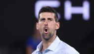 Serbia's Novak Djokovic reacts on a point against France's Adrian Mannarino during their men's singles match on day eight of the Australian Open tennis tournament in Melbourne on January 21, 2024. (Photo by David GRAY / AFP) 