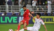 Thailand's midfielder #11 Bordin Phala vies for the ball against Oman's midfielder #20 Salaah al-Yahyaei during the Qatar 2023 AFC Asian Cup Group F football match between Oman and Thailand at the Abdullah bin Khalifa Stadium in Doha on January 21, 2024. (Photo by HECTOR RETAMAL / AFP)