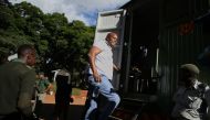 Zimbabwe former legislator and prominent member of the opposition party Citizens Colaition for Change (CCC) Job Sikhala climbs into a prisons truck at the Harare Magistrates Court in Harare on January 24, 2024 after the court convicted him of inciting public violence. (Photo by Jekesai NJIKIZANA / AFP)
