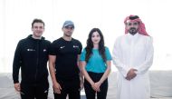 QOC President H E Sheikh Joaan bin Hamad Al Thani poses for a photo with World Aquatics Refugee team.