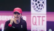 Iga Swiatek of Poland celebrates after scoring a point against Victoria Azarenka of Belarus. 