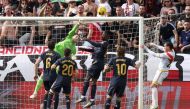 Real Madrid's Ukrainian goalkeeper #13 Andriy Lunin deflects the ball during the Spanish league football match Rayo Vallecano de Madrid and Real Madrid CF at the Vallecas stadium in Madrid on February 18, 2024. (Photo by Pierre-Philippe MARCOU / AFP)
