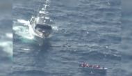 This handout picture released by the Armed Forces of Malta (AFM) on February 23, 2024 shows a patrol boat near of boat of migrants off Malta during a rescue operation. (Photo by Handout / Armed Forces of Malta / AFP)