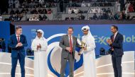 Senior Vice President of ExxonMobil Corporation Neil Chapman presents a souvenir to QTF President Nasser bin Ghanim Al Khelaifi during the final presentation ceremony. 
