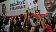 People gather outside anti-establishment candidate Bassirou Diomaye Faye's headquarters in Dakar on March 24, 2024 as results remain expected during the Senegalese presidential elections. Photo by Carmen Abd Ali / AFP. 