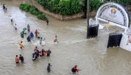 File photo for representational purposes. Pedestrians try to pass a flooded street following heavy rains at Kiembeni district in Mombasa on November 17, 2023. (STRINGER / AFP)

