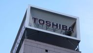 The logo of Japanese industrial group Toshiba is seen on top of a building at their headquarters in Tokyo on December 20, 2023. Photo by Kazuhiro NOGI / AFP