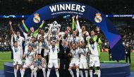 Real Madrid's Nacho Fernandez lifts the trophy to celebrate their victory at the end of the UEFA Champions League final. (Photo by Paul Ellis / AFP)