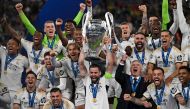 Real Madrid's Spanish defender #06 Nacho Fernandez and Real Madrid's players lift the trophy to celebrate their victory at the end of the UEFA Champions League final football match between Borussia Dortmund and Real Madrid, at Wembley stadium, in London, on June 1, 2024. Photo by Glyn KIRK / AFP.